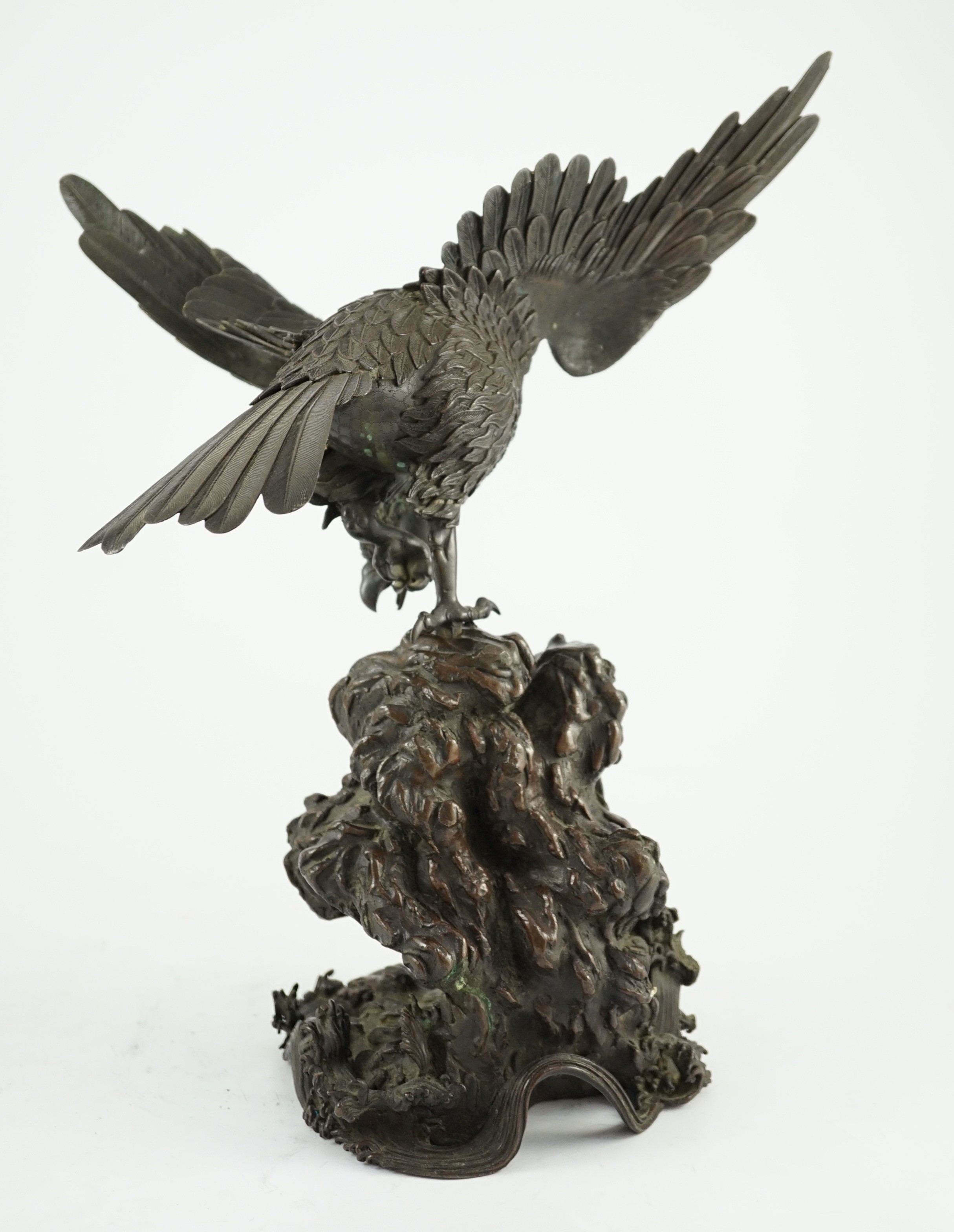 A Japanese bronze model an eagle standing on a rock, Meiji period, 44.5cm high